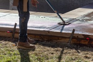 Construction Worker Smoothing Wet Cement