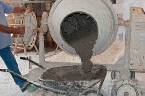 man mixing concrete with concrete mixer - Big Easy Concrete